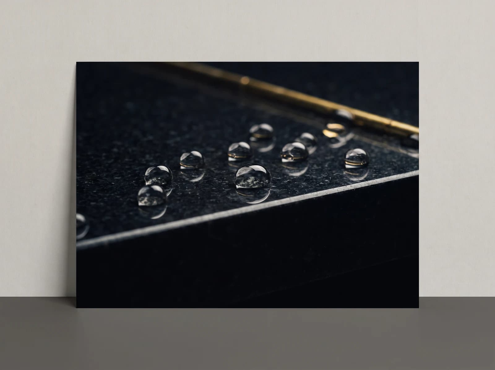 Water droplets on protected dark granite